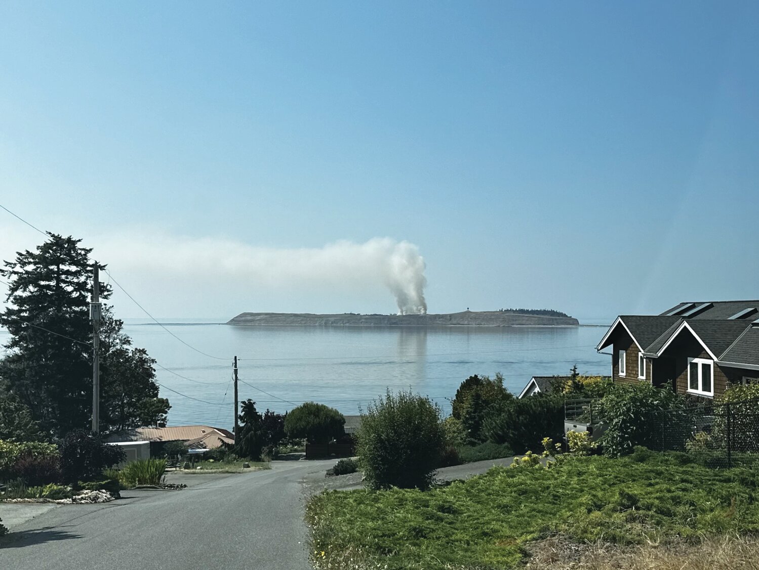 A large plume of smoke extends above Protection Island during last week’s fire.